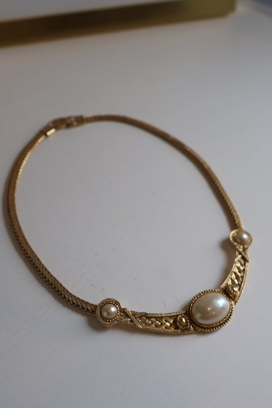 Gold bracelet with pearls on a white background